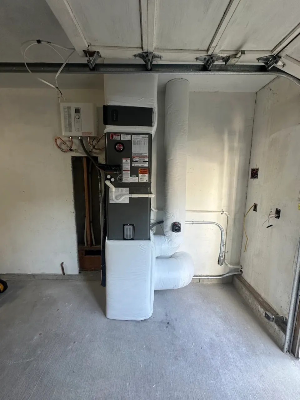 Tankless water heater and furnace install in a garage