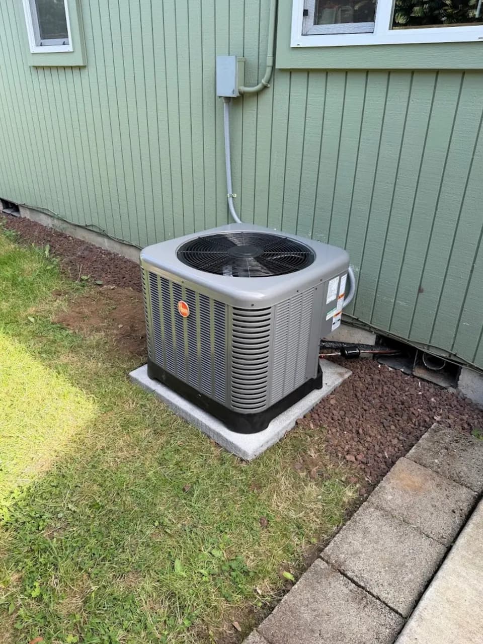 Rheem A/C condenser install, green siding